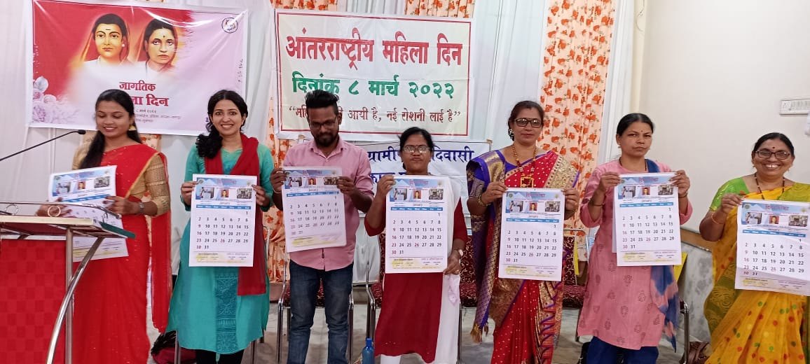 Women holding calendars at an International Women's Day event organised by BGAVS